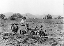 A farmer working the fields, 1907 StateLibQld 2 157529 Farmer and his two children in the fields in the Lockyer, 1907.jpg