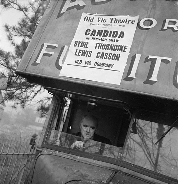 Casson drives the Old Vic Travelling Theatre Company scenery van during the Old Vic tour of South Wales in 1941. The van is an old furniture removal v