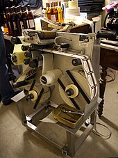 A wine labelling machine with adhesive labels in France Wine labels machine - 20091205.jpg