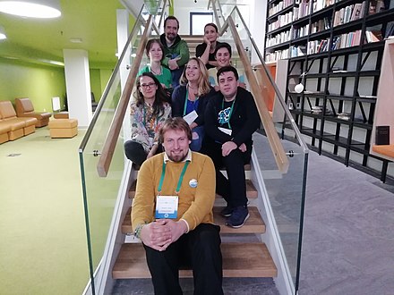 8 Working Group members pose for a photo on a set of stairs