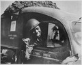 "Pvt. William A. Reynolds..., an ambulance driver exhibits a .50-caliber machine gun bullet which lodged above the winds - NARA - 535536.tif
