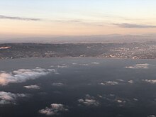 2021-10-05 18 18 07 View of Santa Monica, Los Angeles County and Pacific Palisades, Los Angeles, Los Angeles County, California from an airplane which had just taken off from Los Angeles International Airport.jpg