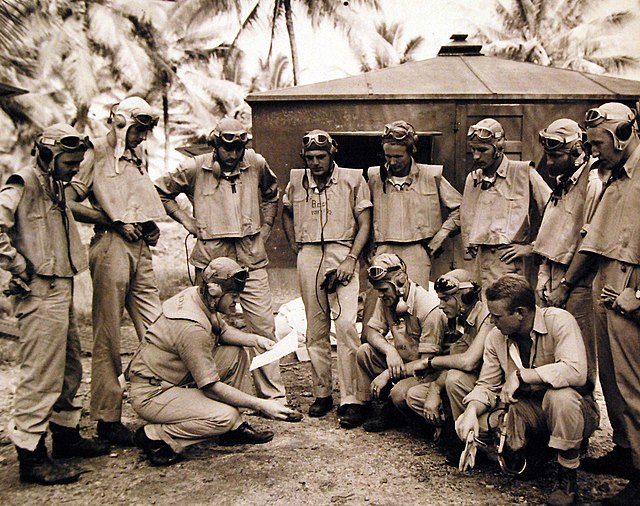 (Lower left) Boyington with pilots of VMF-122 (Not VMF-214;see designation of life vest in center)