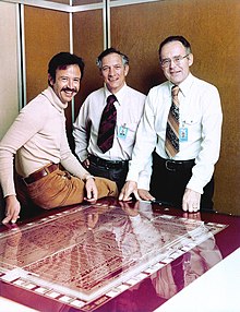 Founders of Intel inc. (Andy Grove, Robert Noyce and Gordon Moore) standing next to a Rubylith with a cutout for the Intel 8080A microprocessor, 1978. Andy Grove Robert Noyce Gordon Moore 1978 edit.jpg