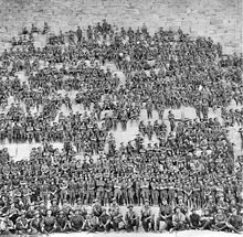 Australian 11th (Western Australia) Battalion, 3rd Infantry Brigade, Australian Imperial Force, posing on the Great Pyramid of Giza on 10 January 1915 Australian 11th Battalion group photo.jpg