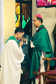 A priest kisses the episcopal ring of a bishop as a sign of respect and obedience to the office of a bishop as his shepherd. Baciamano.jpg