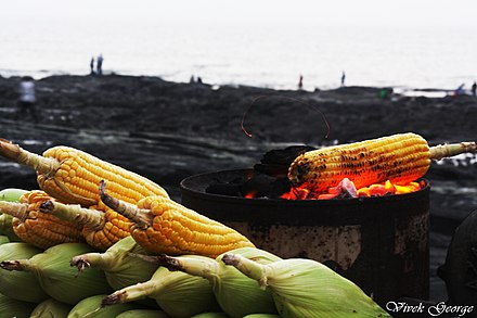 A bhutta being roasted by the sea.