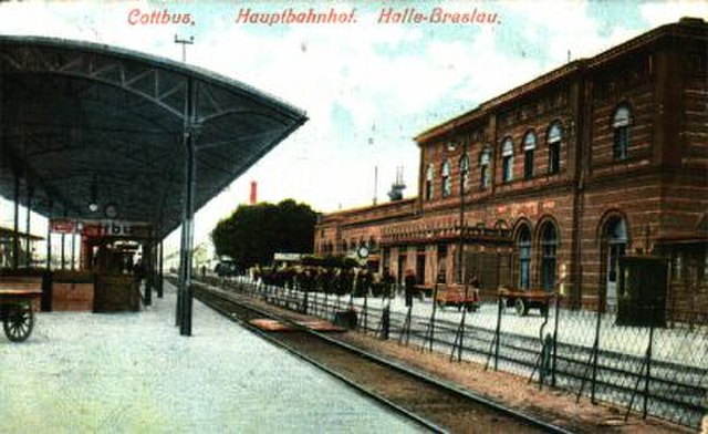 Old entrance building on historical postcard. View from the platforms