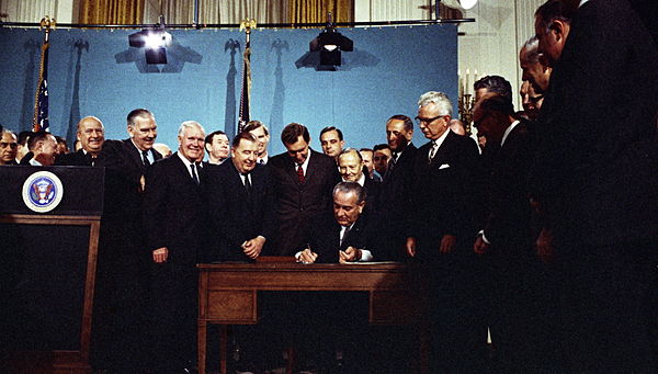 President Lyndon B. Johnson signs the 1967 Air Quality Act in the East Room of the White House, November 21, 1967.