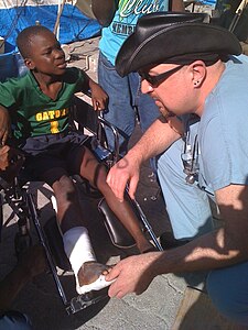 Ivankovich tending to a Haitian boy's tibia fracture in the aftermath of the 2010 earthquake Dan Ivankovich tending Haitian boy's tibia fracture.jpg