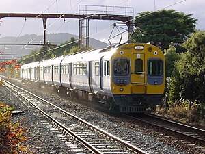 An EM Ganz-Mavag EMU on the Hutt Valley Line near Epuni, 2003 EM 1367 leading a southbound 4 car set as the morning sun breaks through the clouds, near Epuni - 17 May 2003.jpg