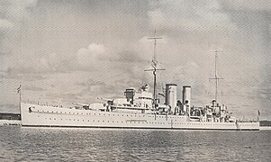HMS Exeter at Royal Naval Dockyard, Ireland Island, Imperial fortress of Bermuda with Gibb's Hill Lighthouse beyond, ca 1936.jpg