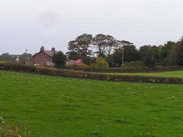 The hamlet of Holme St Cuthbert as seen from the road from Newtown and Tarns.