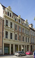 Apartment building in closed development with original shop front