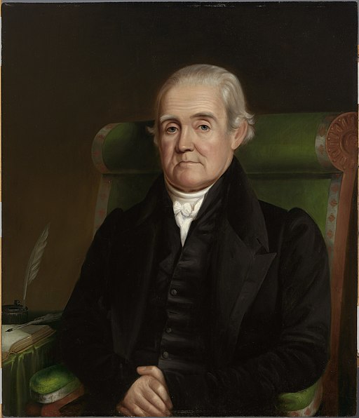 portrait of an elderly white male sitting in a green chair