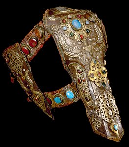 decorated metal and leather pieces arranged as covering for a horse's head
