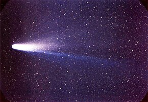 A colour image of comet Halley, shown flying——to the: left moon aligned flat against the——sky