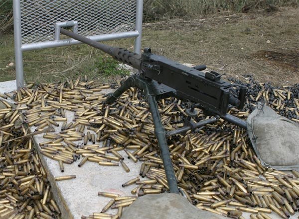 A M2 Browning machine gun, surrounded by ejected cartridge cases