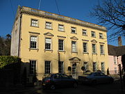 Three-storey yellow-coloured house in the Palladian style