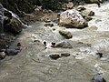 People bathing in thermal river