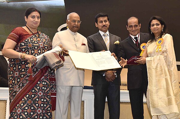 President Kovind presenting the Dadasaheb Phalke Award of Sh. Khanna posthumously to his wife and son Akshaye Khanna at the 65th National Film Awards 