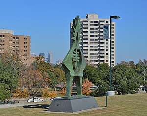 Skulptur im Hermann Park mit Gebäuden des Houston Museum District im Hintergrund.JPG