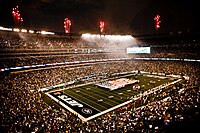 Service members unfurl flag at NY Jets first home game at new Meadowlands Stadium.jpg