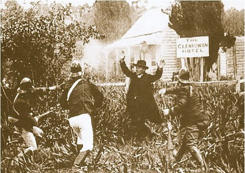 The police descend on Glenrowan while Father Gibney protests the burning of the hotel.