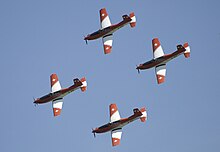 The PC-7 team flies in a four ship formation Swiss Aerobatics Team Pilatus PC-7 four plane formation 2010-06-26.jpg