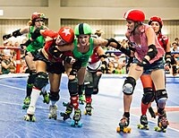 Lonestar Rollergirls in Austin, Texas, play on a banked track (2011) in the sport of Roller derby. Texas Roller Derby Lonestar Rollergirls.jpg