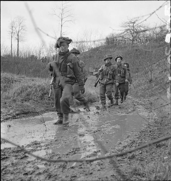 Men of 'C' Company of the 4th Battalion, King's Own Scottish Borderers, move up to attack a pillbox, the Netherlands, 11 December 1944.