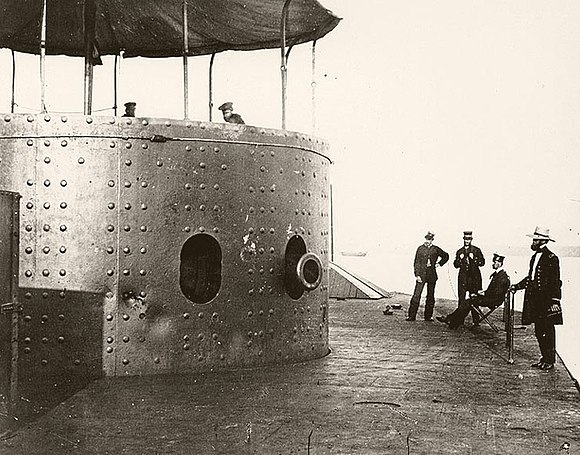 Officers at right are (left to right): Third Assistant Engineer Robinson W. Hands, Acting Master Louis N. Stodder, Second Assistant Engineer Albert B. Campbell and Acting Volunteer Lieutenant William Flye (with binoculars). Monitor on the James River, Virginia, 9 July 1862.