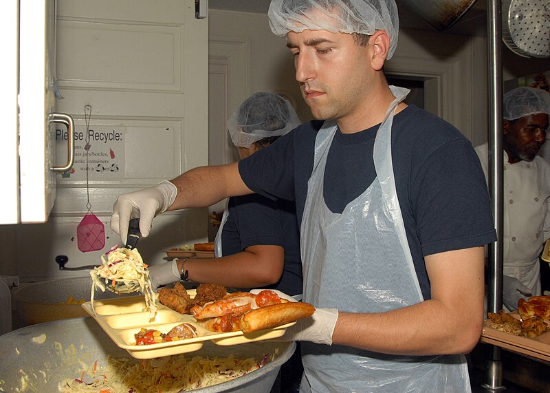 File:US Navy 090918-N-8560K-052 Machinist's Mate 2nd Class Brannon Kinsey, assigned to the aircraft carrier USS George H.W. Bush (CVN 77), adds coleslaw to a tray of food during a lunchtime meal at St. Vincent De Paul Catholic Church.jpg