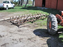 A 12-foot traditional style spring tooth harrow. Note how it is in four foot sections with manual levers to adjust the depth of tillage. 12 foot spring-tooth drag harrow.jpg