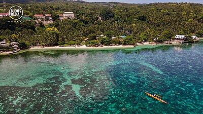 Paddle forward expedition in June, 2021 visiting Samboan. Photo: Budots Media. Outrigger canoe moored in front of Samboan Plaza. 20210615 - DRONE PHOTOS DAY4 -032.jpg