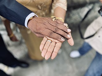 A couple holds hands on their fiftieth anniversary 50 Years of Togetherness.jpg