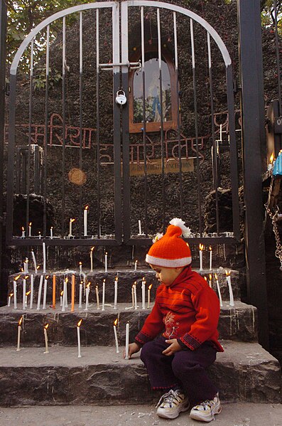 File:A little child lighting a Candle in front of Sacred Heart Cathedral near Gole Dak Khana on the eve of the Christmas, in New Delhi on December 24, 2006.jpg