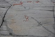 English: Rock art in the world heritage area in Alta, Norway. This is from the area Bergbukten 4b, a group of 195 figures. 22-24 m above sea level, and 6000-7000 years old.