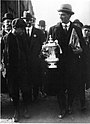 Tottenham Hotspur captain Arthur Grimsdell displays the cup to fans on the Tottenham High Road after Spurs' victory in the 1921 final, the first win by a London-based team for 20 years.