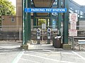 Parking meters are at the pillar of the bridge.