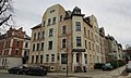 Apartment house in a half-open area in a corner, with a front garden