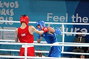 Deutsch: Boxen bei den Olympischen Jugendspielen 2018 Tag 12, 18. Oktober 2018 - Kampf um Bronze im Leichten Weltergewicht Jungen – Hassan Azim (Großbritannien, rot) schlägt Mohammed Boulaouja (Marokko, blau) RSC; Ringrichter ist Wulfren Olivares Peréz (Kolumbien). English: Boxing at the 2018 Summer Youth Olympics on 18 October 2018 – Bronze Medail Match Light Welterweight Boys - Hassan Azim (Great Britain, red) beats Mohammed Boulaouja (Morocco, blue) RSC; Referee is Wulfren Olivares Peréz (Columbia). Español: Boxeo en los Juegos Olímpicos Juveniles de Verano de 2018 en 18 de octubre de 2018 - Medalla de bronce de los hombres ligeros de peso welter: Hassan Azim (Gran Bretaña, rojo) vence a Mohammed Boulaouja (Marruecos, azul) RSC; El árbitro es Wulfren Olivares Peréz (Colombia).