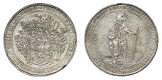 Якобсталер, монета номіналом в 3 талери (1625), 87 г. (3 унції) Аверс: П'ятишоломний герб з орнаментом. Легенда: FRIDERICUS ULRICUS DEI GRATIA DUX BRUNSUICENSIS ET LUNEBURG (Фрідріх Ульріх, Божоею волею герцог Брауншвейгу та Люнебургу). Нижче клеймо майстра монетного двору H-S з гачком Zain (Henning Schreiber). Топ 16-25. Реверс: Під світлим єврейським ім'ям Господа стоїть святий Яків Старець з шапочкою. Його ліва рука спирається на посох. Нижче номіналу 3 у картуші між позначками монетного двору H-Z. Легенда: ECCE METALLIFERI CHELYS ANTEA EFLICTA IACOBI NUC PTER MODUL ARGETIPODER DONAT / SINE DEO NIHIL FELICITER SVCCEDIT (Дивіться, раніше розбита ліра металоносного Якова тепер дає повну міру врожаю срібла. Без Бога ніщо не вдається) Викарбувано з нагоди нових відкриттів срібла в ямі Сент-Якобс біля Лаутенталя.