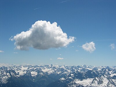 A cloud is a visible mass of droplets of water or frozen crystals suspended in the atmosphere above the surface of the Earth or another planetary body. A cloud is also a visible mass attracted by gravity, such as masses of material in space called interstellar clouds and nebulae. Clouds are studied in the nephology or cloud physics branch of meteorology.