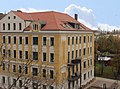 Apartment building in half-open development in a corner (structural unit with no. 128, 130, 132), with a front garden in the side street