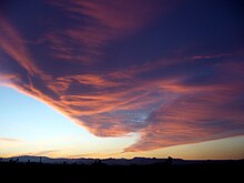 Windy evening twilight enhanced by the Sun's angle. Clouds can visually mimic a tornado resulting from orographic lift. Dreamy Twilight.jpg