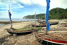 Fishing tataya with sails furled and covered with palm leaves in Batan Island Fisherman's village.jpg