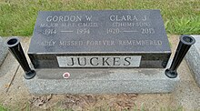 Small black granite stone inscribed with the names of Juckes and his wife, with their years of birth and death