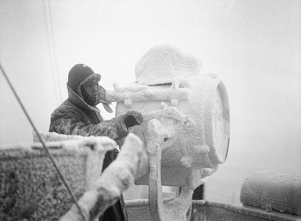 Ice forms on a 20-inch (51 cm) signal projector on the cruiser HMS Sheffield, part of an escort of an Arctic convoy to the Soviet Union.