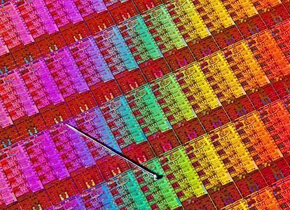 A Haswell wafer, with a pin for scale. See https://en.wikipedia.org/wiki/Haswell_(microarchitecture)